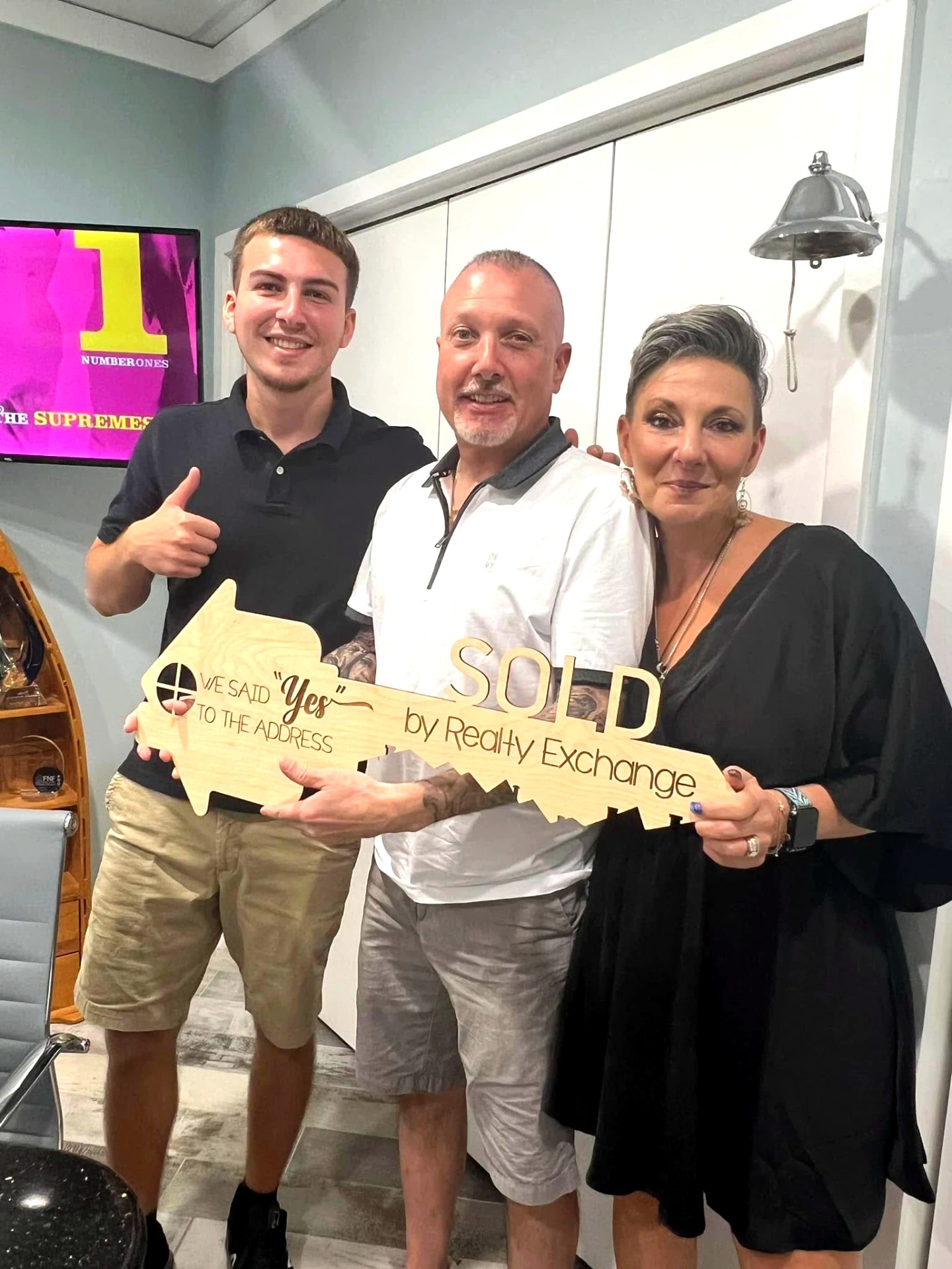 Riley celebrating a sold home with clients